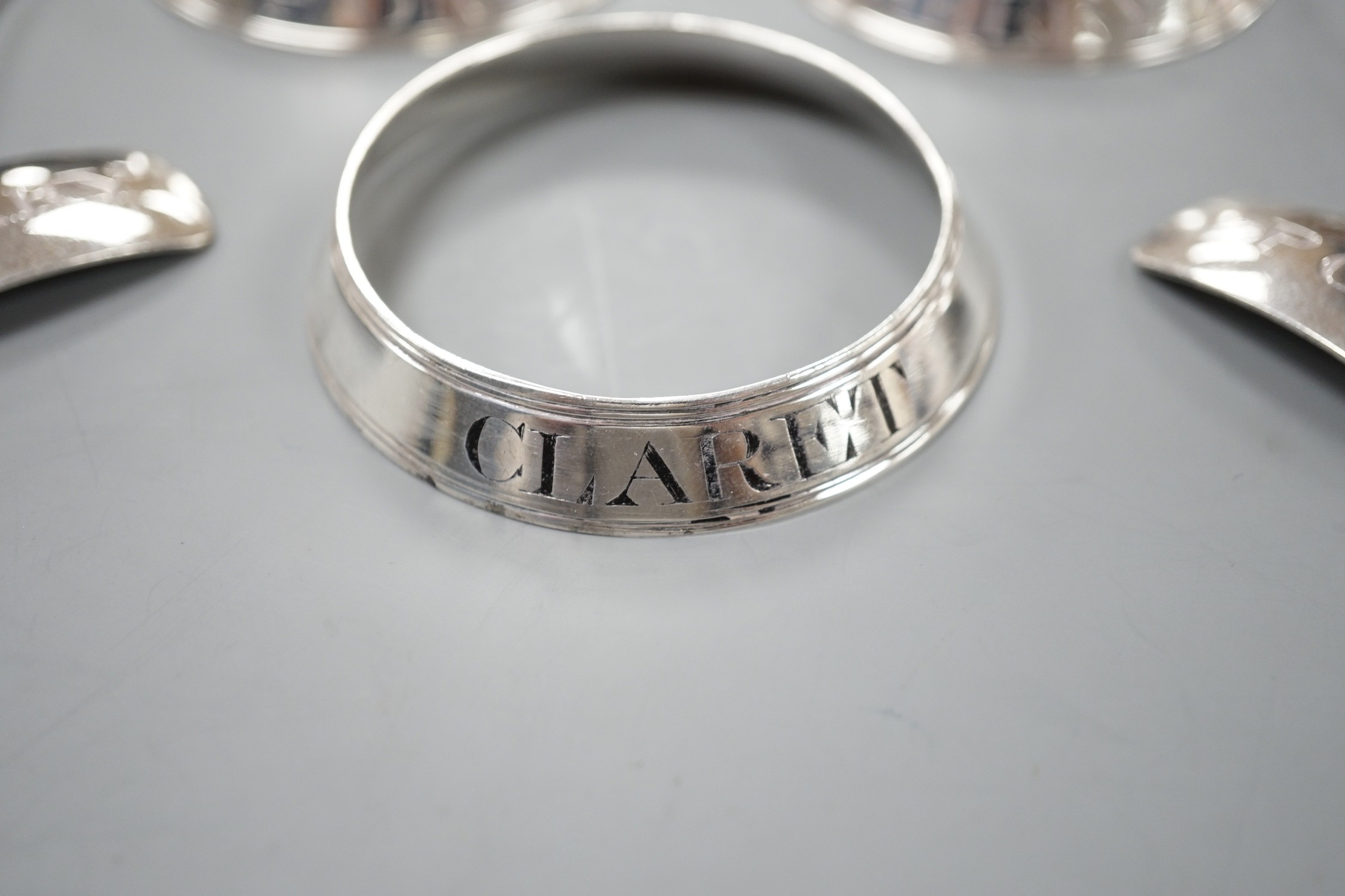 A set of three George silver decanted wine collar labels, Robert Barker, London, 1793 and a pair of similar silver wine label collarettes by Peter & Ann Bateman, London, 1798.